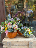 Calabazas naturales con flores de colores junto al escaparate de Lorena Marco
